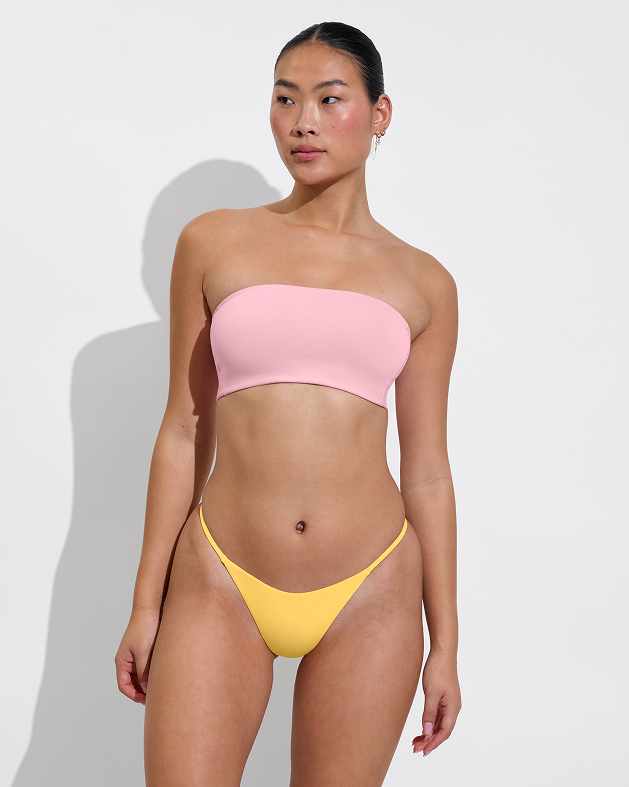 Woman in tubular top in delight paired with skinny dip bottom in mango