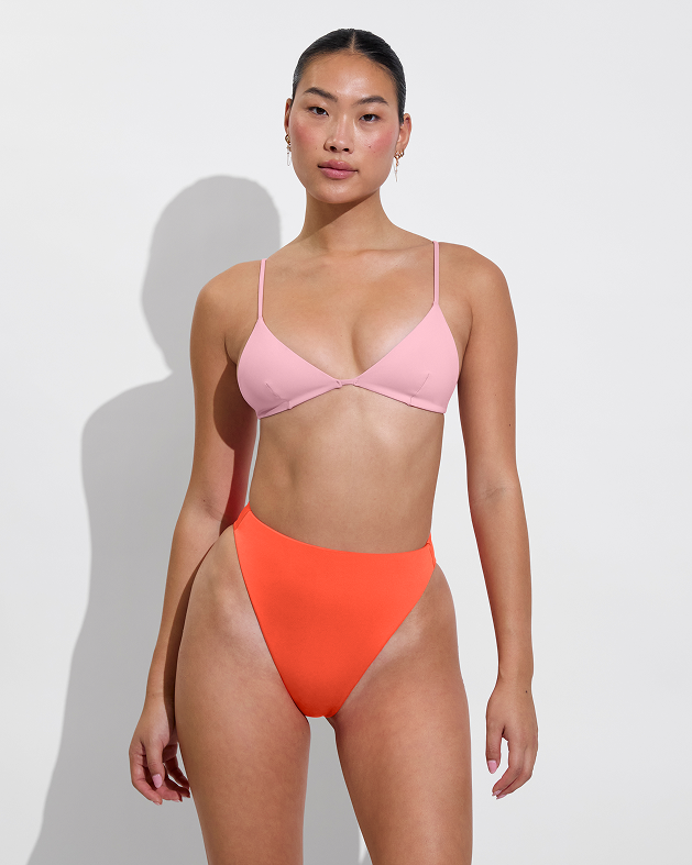 Woman in sandy top in delight paired with super hi hi bottom in aperol