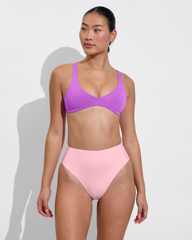 Woman in plunge top in aloha paired with hi hi bottom in delight