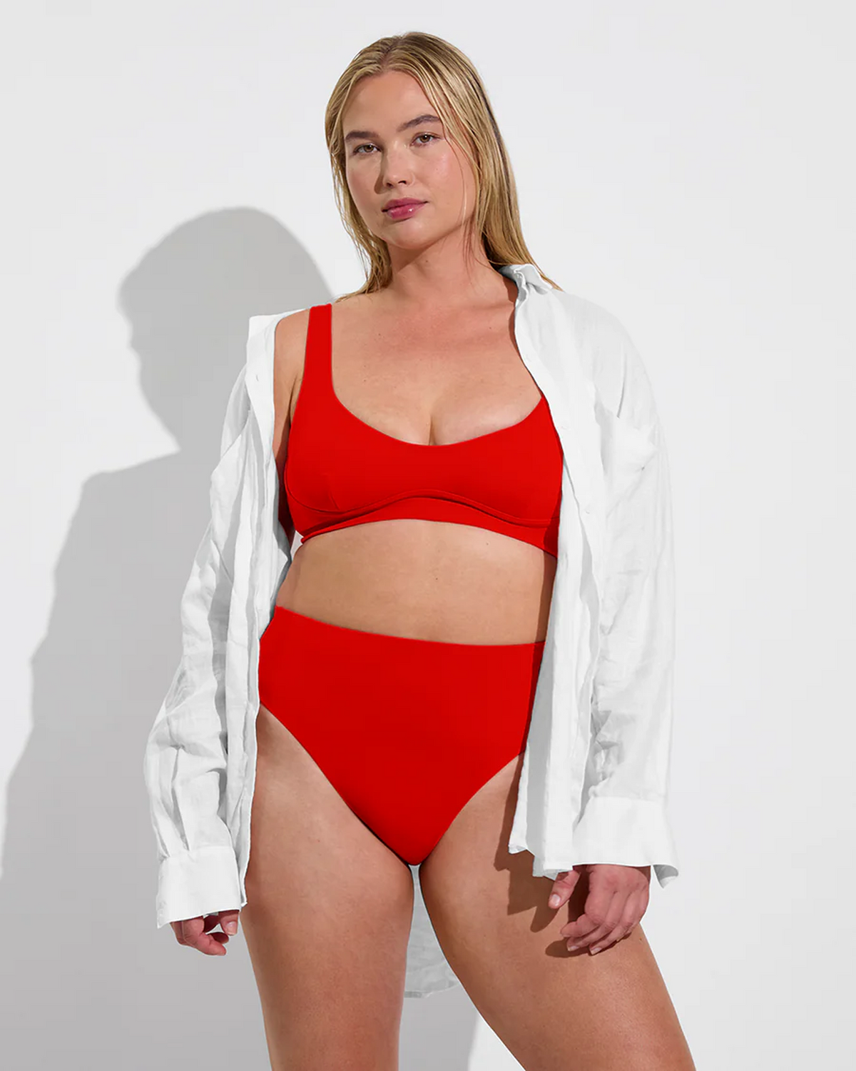 Woman in Club Top D and Hi Hi Bottom in Sweet Chili Heat paired with Getaway Button Down in Coconut 