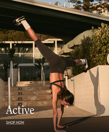 Person doing a handstand outdoors in Left On Friday active with 'Active' and 'Shop Now' text overlay.