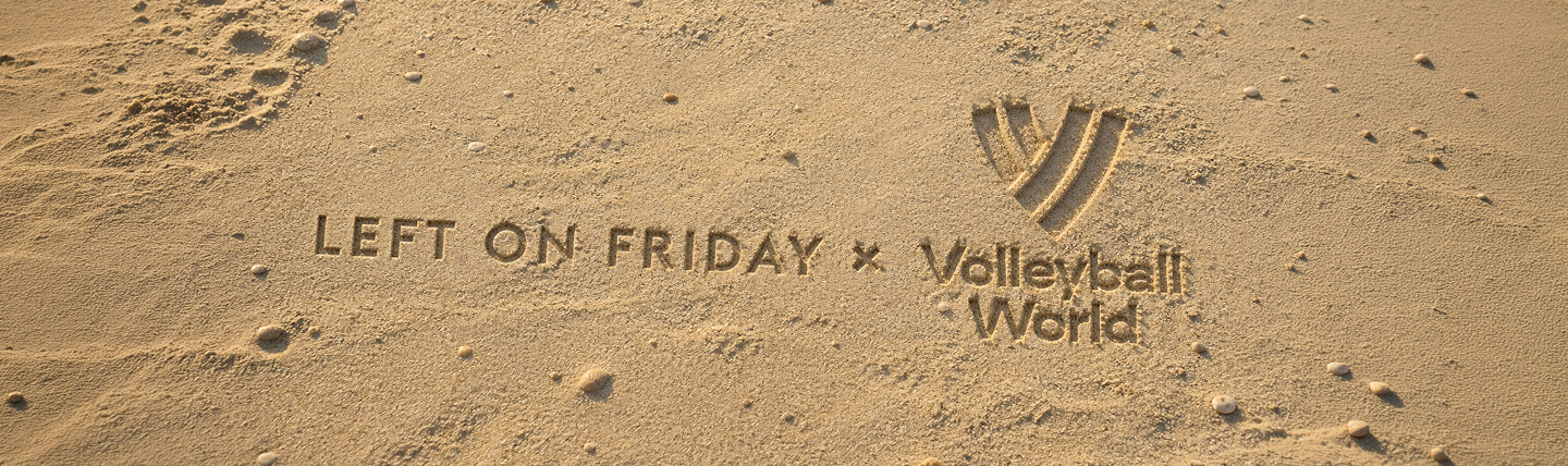 Sand with the text 'LEFT ON FRIDAY x Volleyball World' and a Volleyball World logo printed or stamped into it.