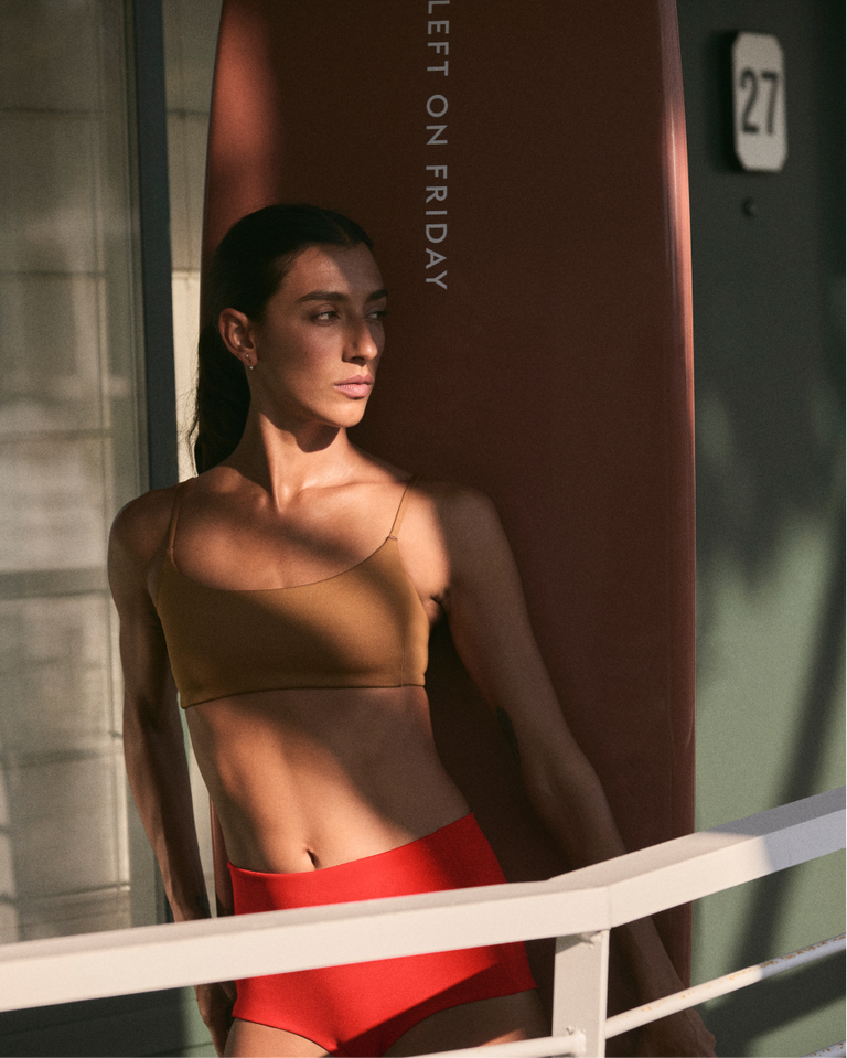 Woman in pool days top in tan lines + barrel bottom in sweet chili heat