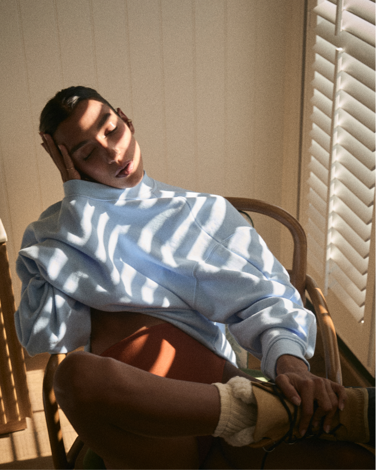 Person wearing a Field Day Sweatshirt in Blue Skies and Bronze Hi Hi bottoms in a bathroom.