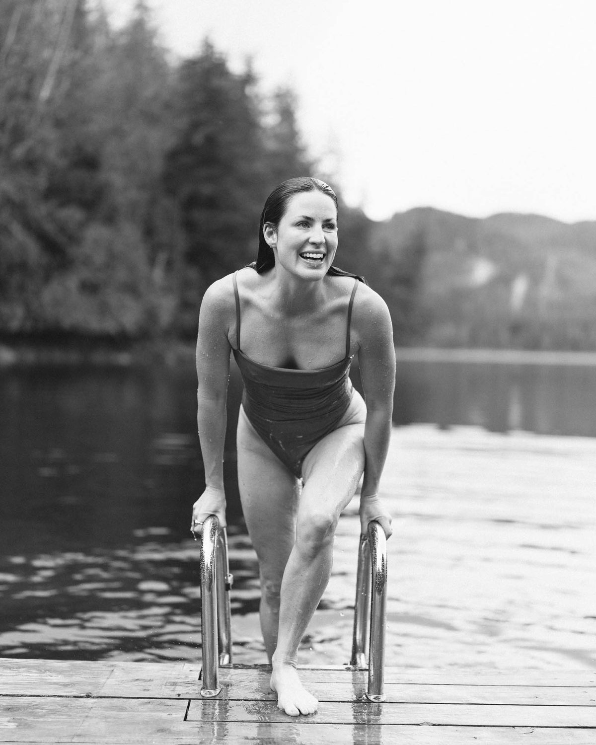 Woman stepping out of the lake