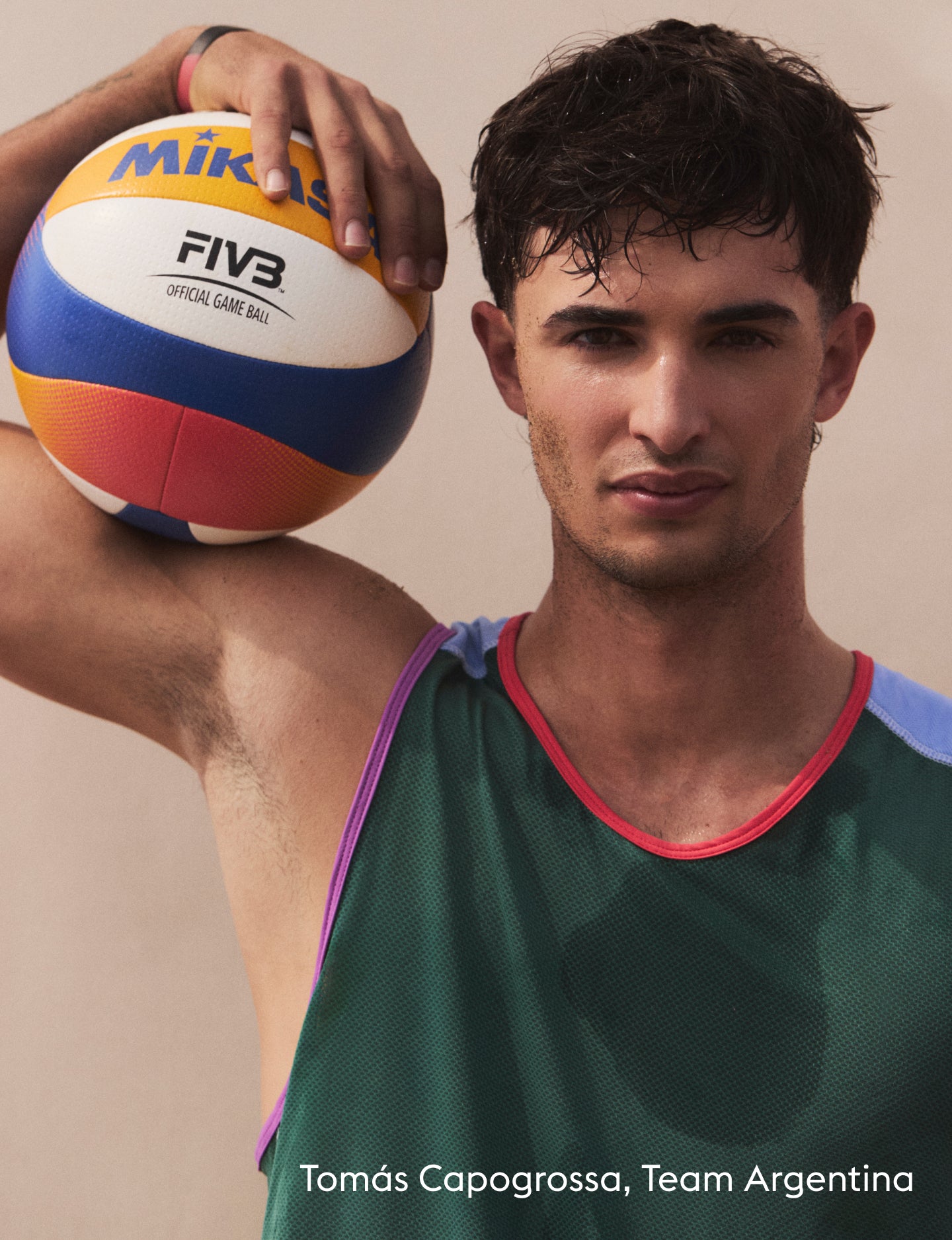 A man in a green athletic jersey holding a Mikasa FIVB official volleyball, with the text 'Nicolás Capogrossa, Team Argentina' at the bottom.