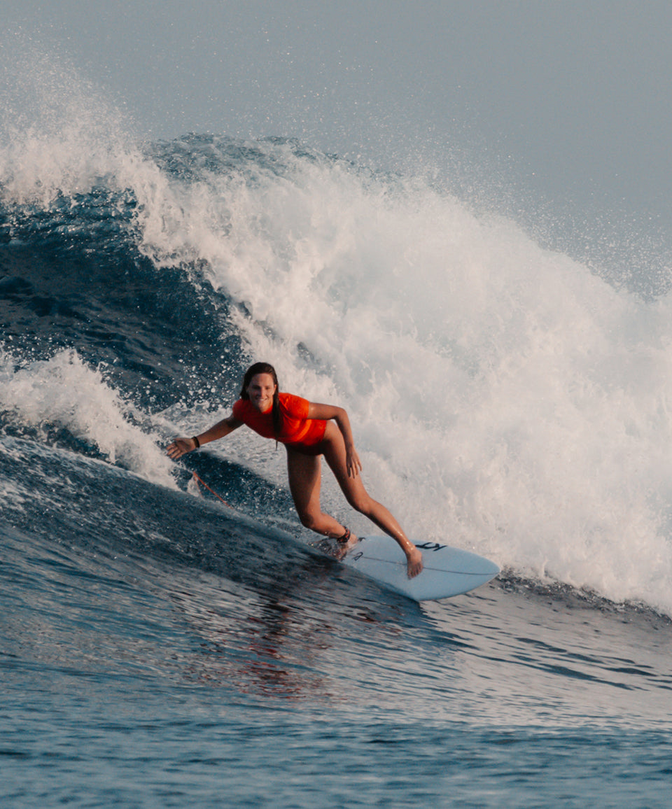 Person surfing on a wave in the ocean