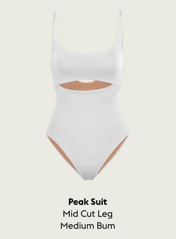 White Peak Suit with cut-out design on a light gray background