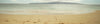 Girls running towards the ocean with surfboards